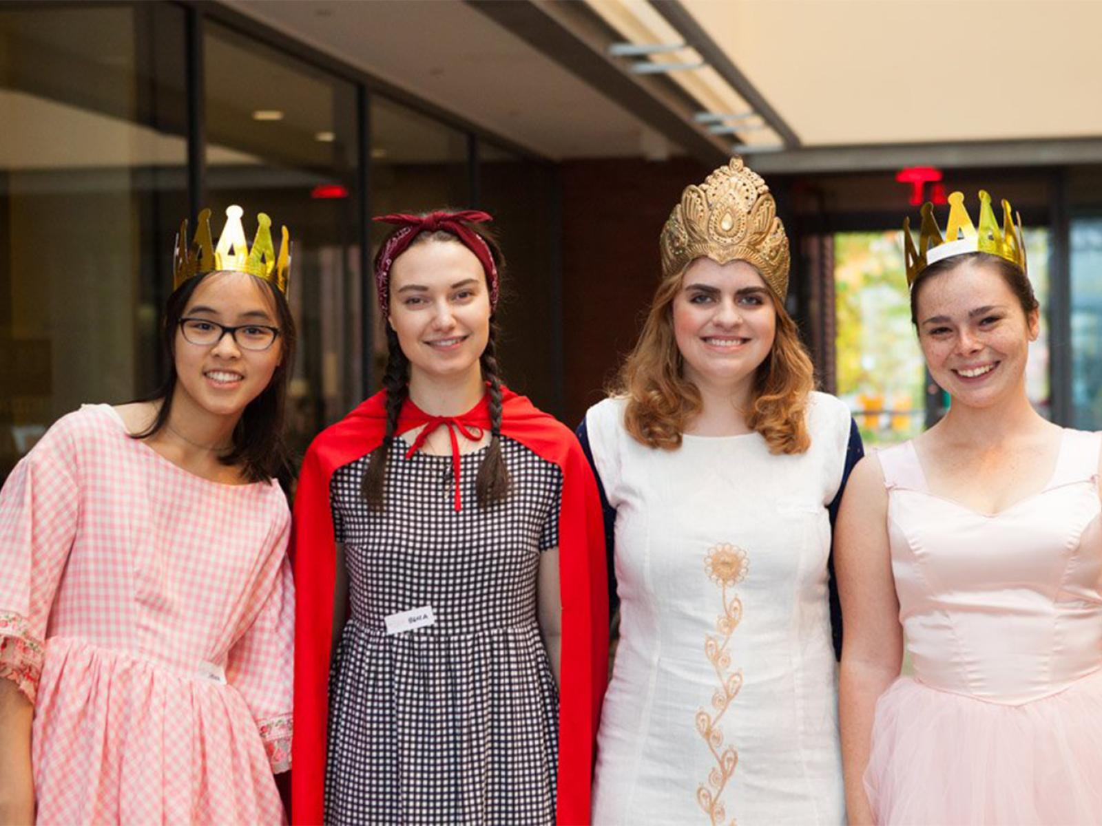 Four students with homemade crowns on in SCMA atrium