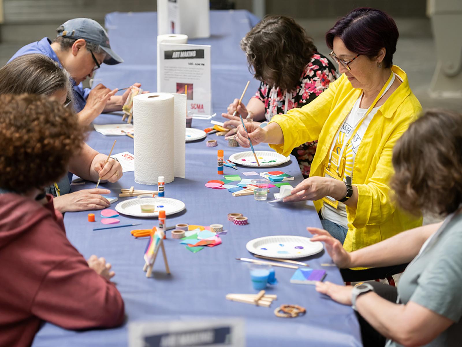 People sitting at a table making art