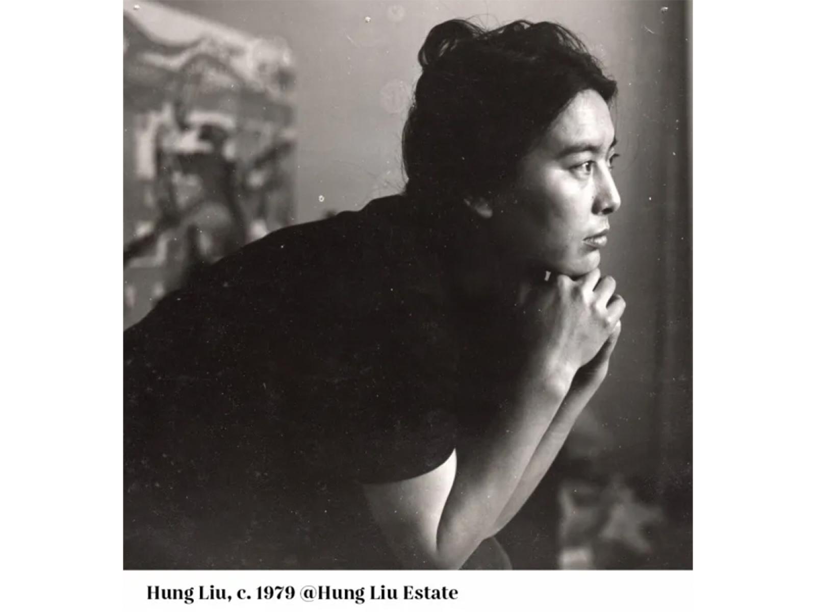 Black and white photo of a woman leaning on her hands looking to the left of the camera