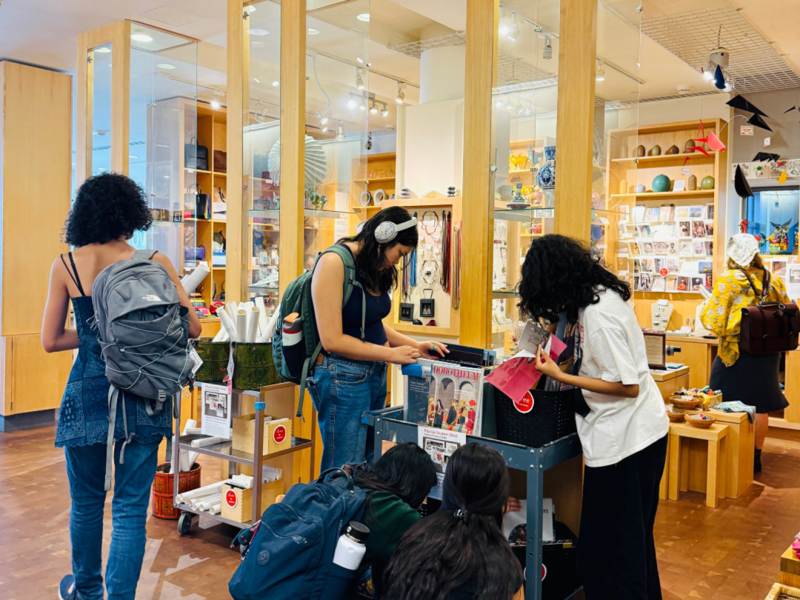 Students in museum shop sifting through items 