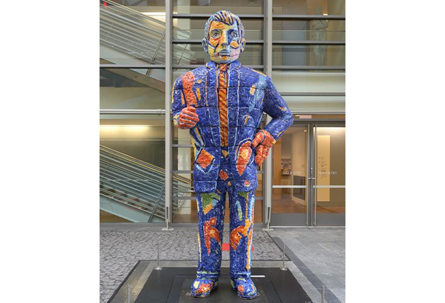 Tall colorful painted ceramic sculpture of an oversized man