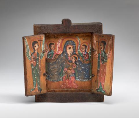 Image of a square, wooden triptych. On the central panel, the virgin, cloaked in blue, and child are flanked by two angels holding swords. Each side panel depicts an angel dressed in green and red holding a staff and a sword.