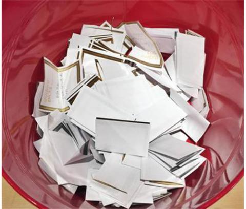 red bucket containing slips of white paper