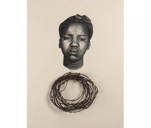 frontal head of a frowning African American woman with her hair in an up do over a circlet of real barbed wire encased in a black box