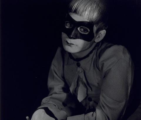 portrait of white man wearing dark clothes and a mask