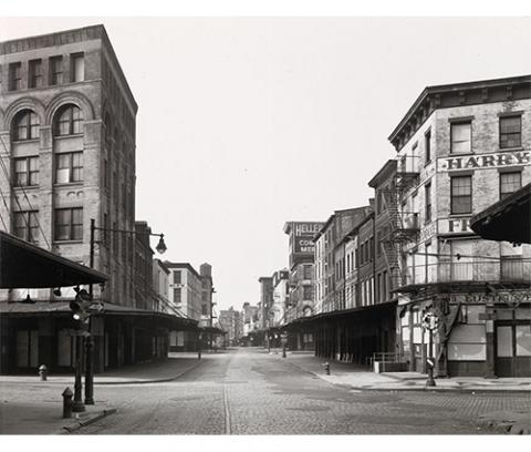 exterior, cobblestone street with three to seven story city buildings empty of all cars and people