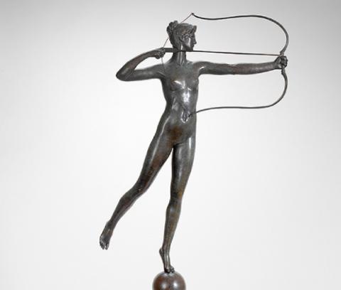 triangular base with knob to turn ball on which proper left leg of nude female in midst of drawing arrow in bow rests, proper right left extended back; mythology