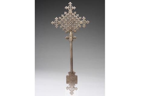 An image of a silver cross on display at the Smith College Museum of Art