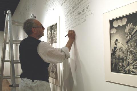 Man drawing on gallery wall