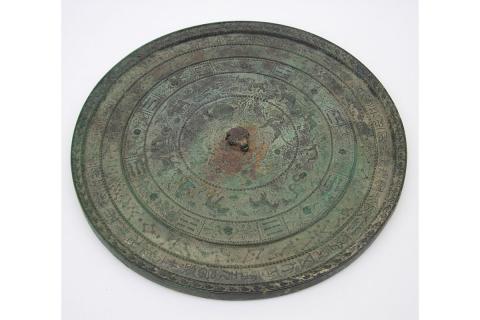 Green circular disc that looks like oxidized  metal