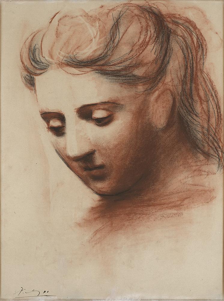 Ochre drawing of a head of a woman with long hair gazing downwards