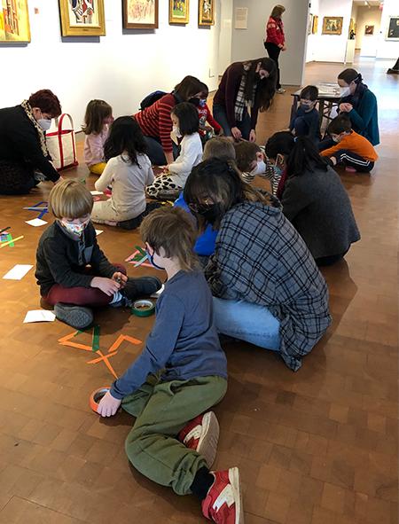 Students with adults working on project on gallery floor