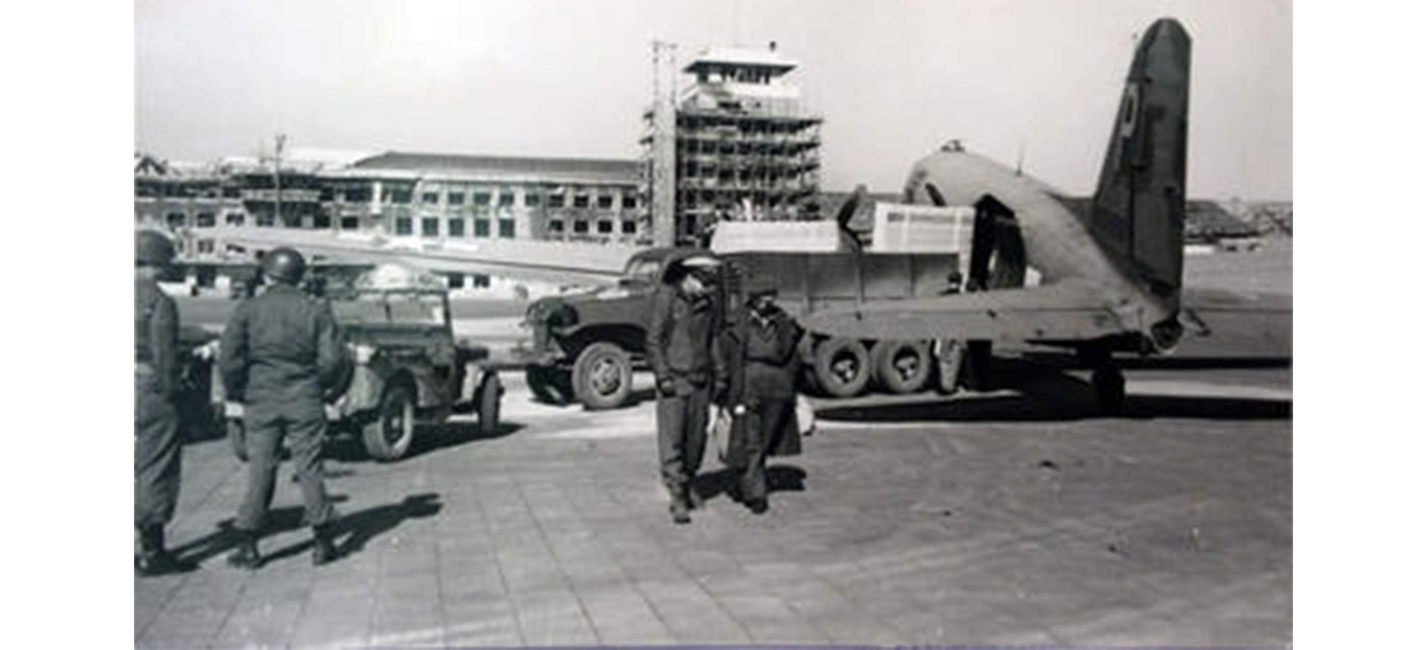 soldiers walking away from a plane on a runway