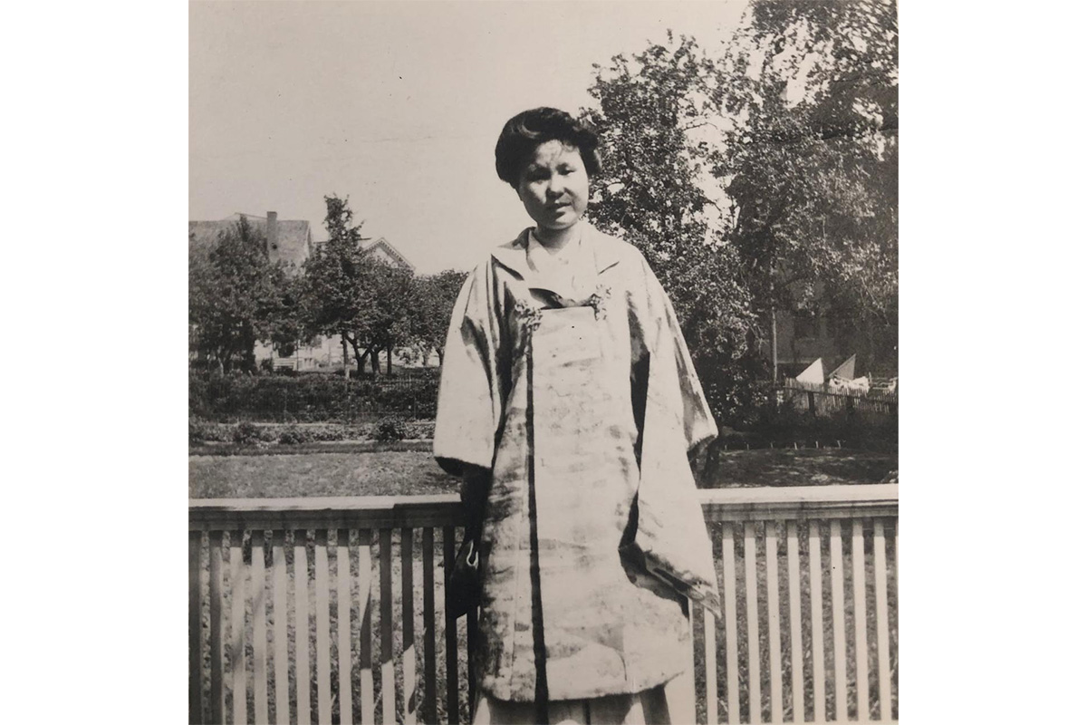 "asian woman standing on bridge"